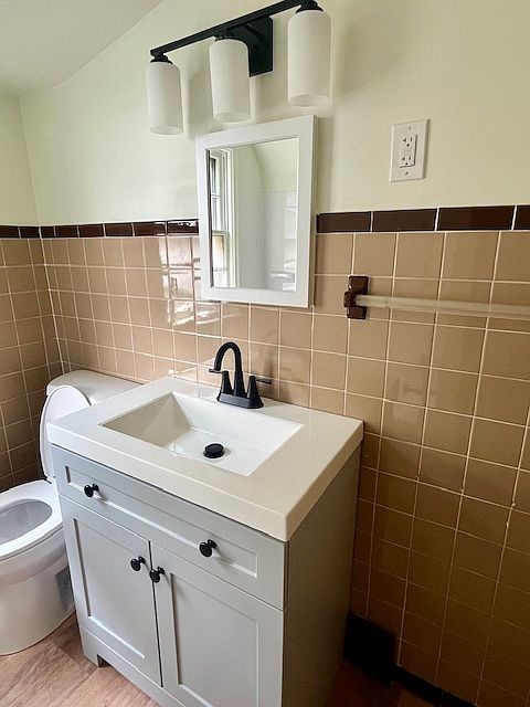 New vanity, light fixtures, medicine cabinet, toilet and flooring,