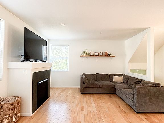 Living Room with gas furnace and TV on top of mantle.