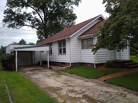 Side with garage and carport