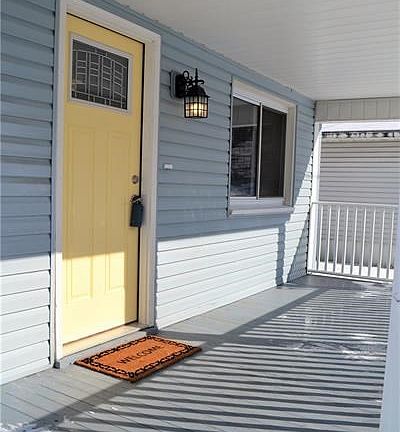 New entry door and porch gives inviting curb appeal