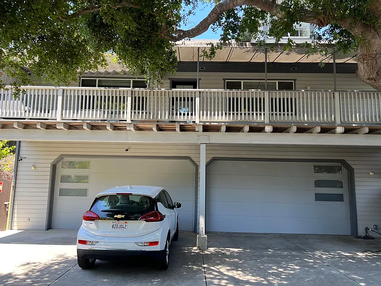 View of the property and 2nd floor penthouse above the trees