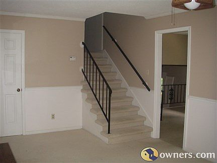 Stairway to upper level with 3 bedrooms and 2 full baths.