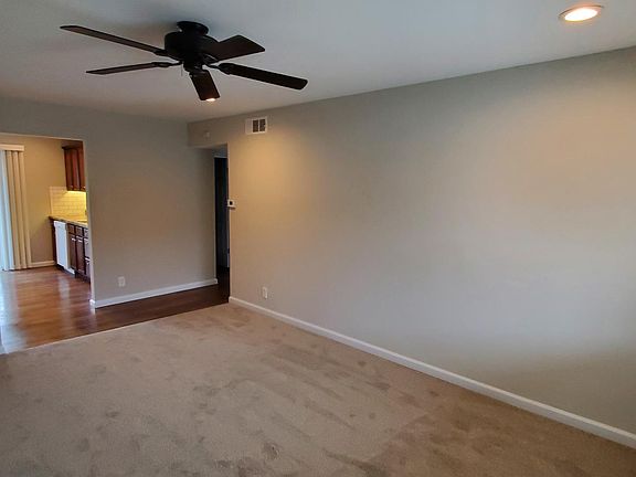 Living room with ceiling fan and can-lights