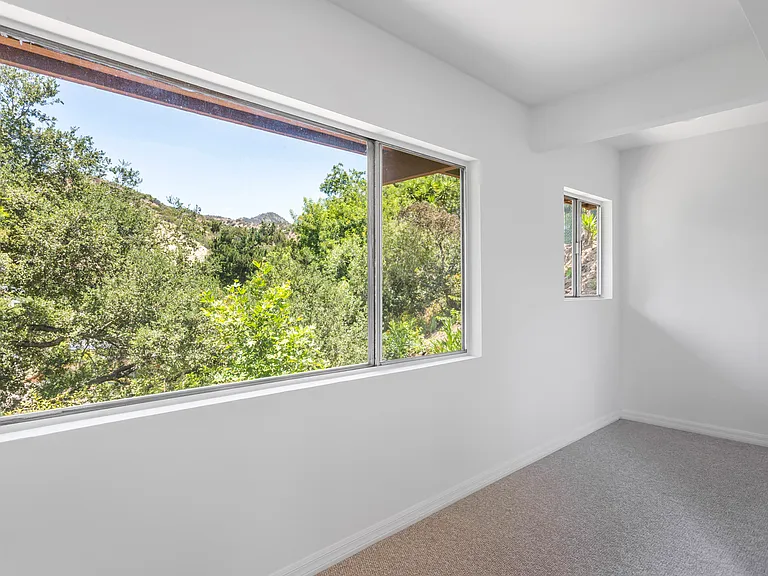 Windows frame stunning views from every window in this two-story home.
