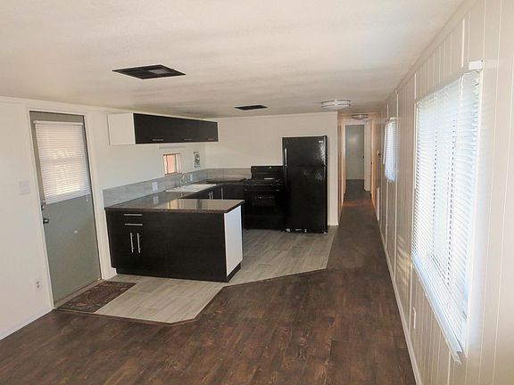 Ikea Kitchen with gas stove, tile floor, ice maker fridge