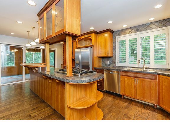 Kitchen with custom cabinetry, hard wood floors and stainless appliances- Viking Range and Viking Oven