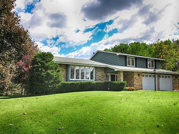 Attractive modified 2-story on 1/2 acre treed lot in coveted 'Hadley Hills'