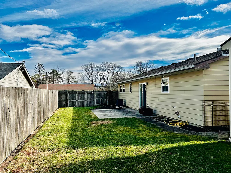 Fenced back yard, stamped patio, sidewalk to front of the house.