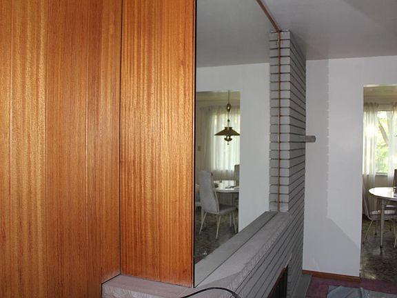 wood paneling above fireplace