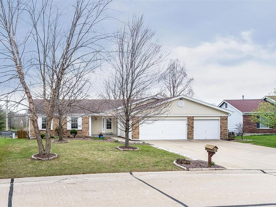 Curb appeal at its best with brick vinyl siding, covered porch and 3 car garage!