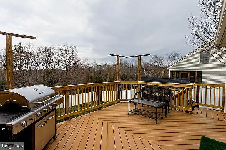 Deck has been stained white. It does not include a BBQ but does include some patio furniture.