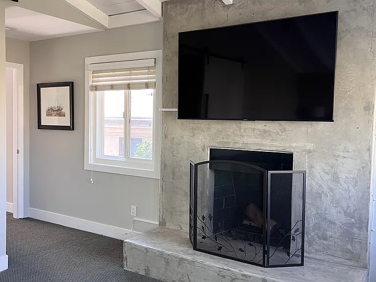 Primary bedroom fireplace and bigscreen tv
