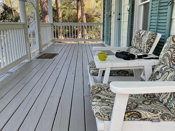 Porch spans width of house. Excellent bird watching site!