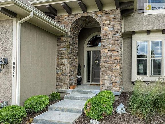 The front elevation of this home is eye-catching from the curb with pretty details and an established landscape.