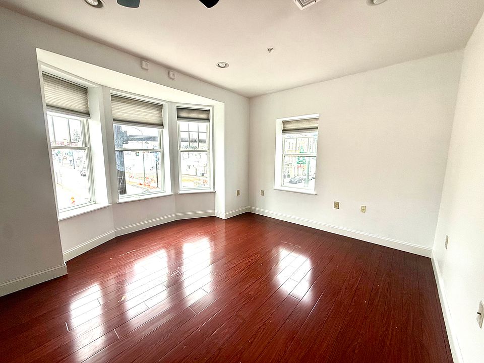 Living room with 3 bay window overlooking the new town square