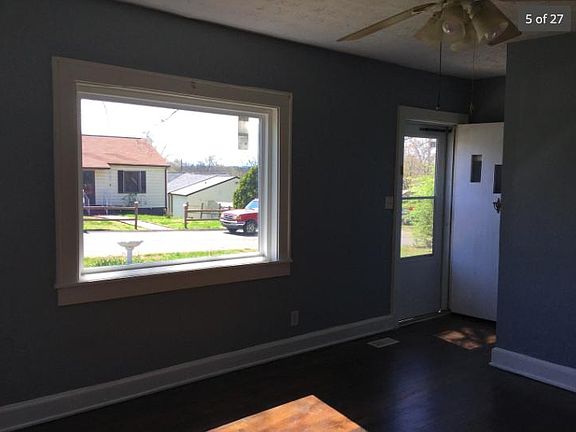 Living room with new windows and original hardwood floors