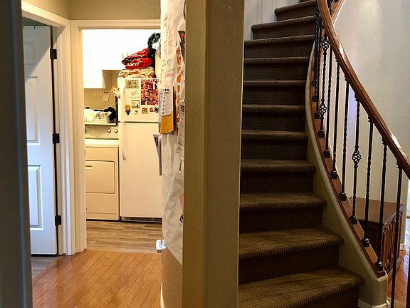Behind stairs-laundry + bath