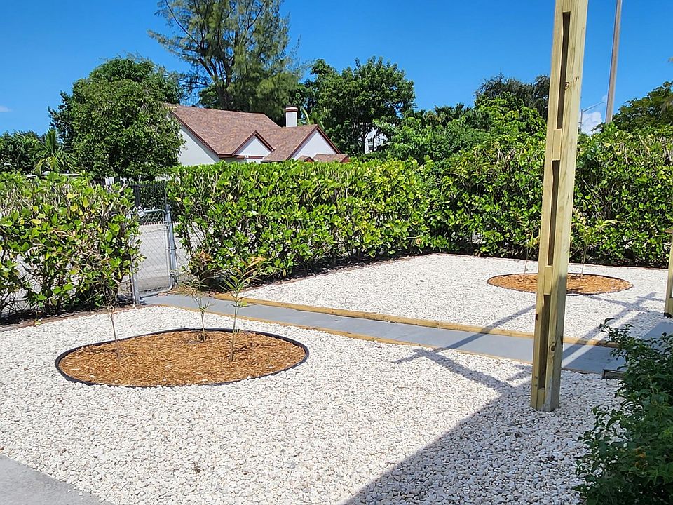 Newly landscaped low maintenance front yard, with privacy hedges all around.
