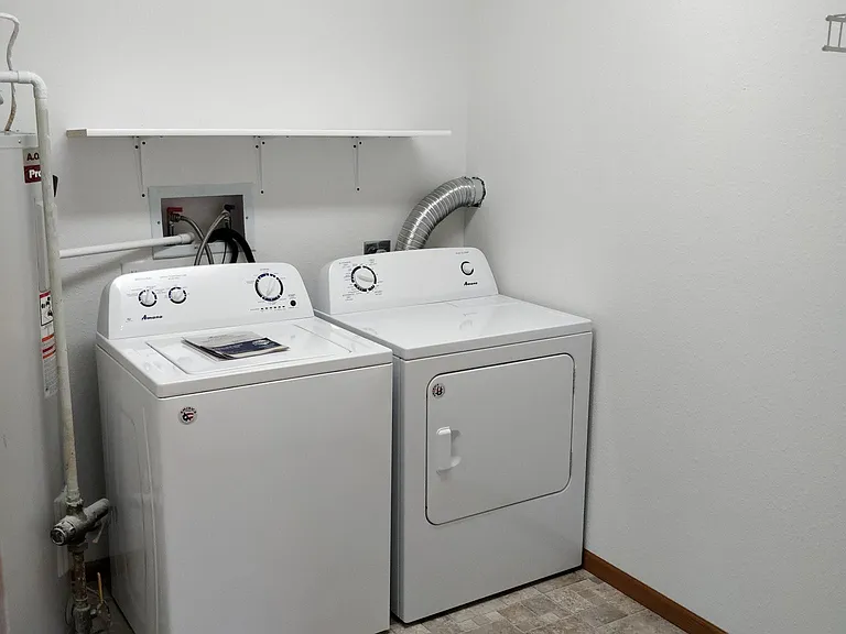 In-unit laundry room with w/d, shelves and storage room.
