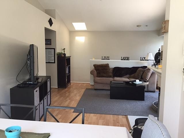 Living room. Stairs in upper left lead down to front door entranceway and double garage with full ceiling to floor cabinets.