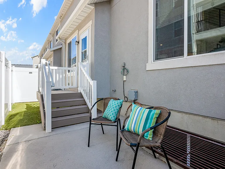 Fenced backyard with artificial grass