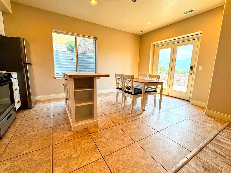 Full kitchen, with table/4 chairs, Island, fridge, stove, microwave, dishwasher.