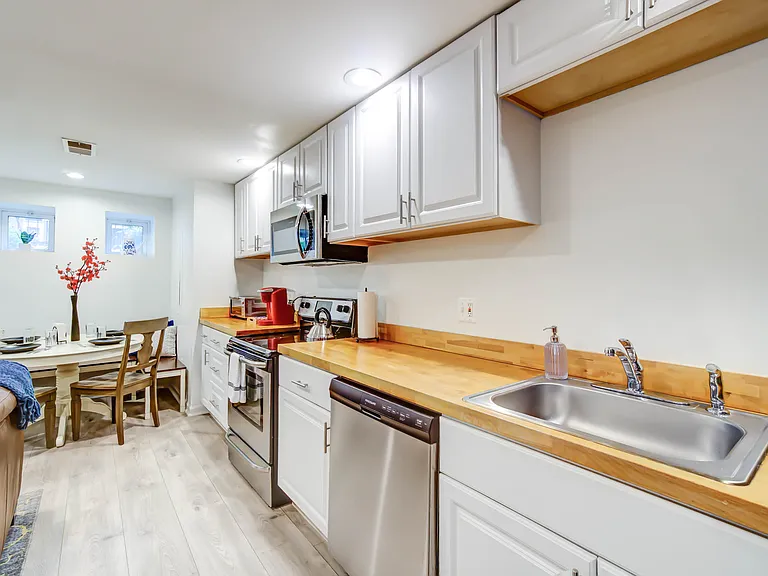 The well-appointed kitchen is equipped with full-size appliances, offering both functionality and ease for everyday cooking.