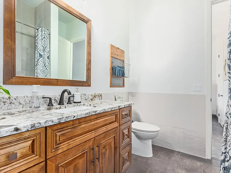 SHARED BATHROOM, BETWEEN BEDROOM TWO AND THREE. THIS BATHROOM HAS A STANDARD TUB/SHOWER.