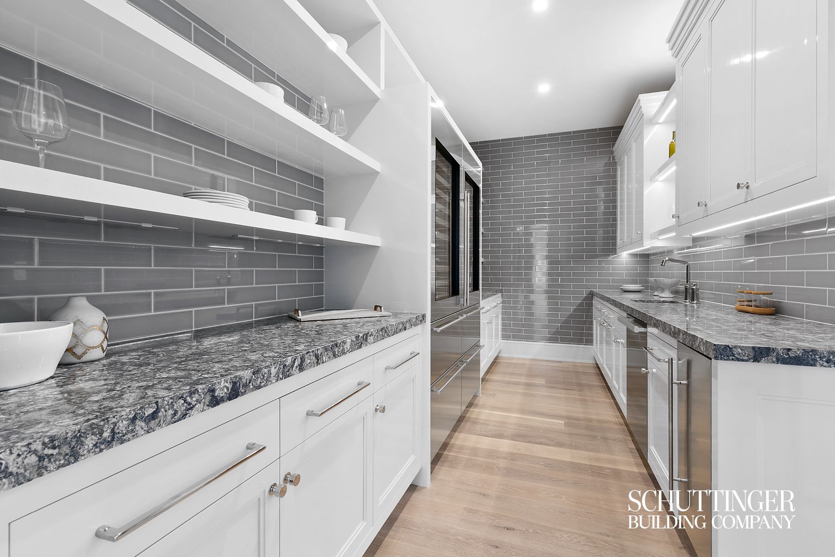  Butler's Pantry featuring 2 Sub Zero Wine Towers Side by Side and Tiled Walls Throughout 