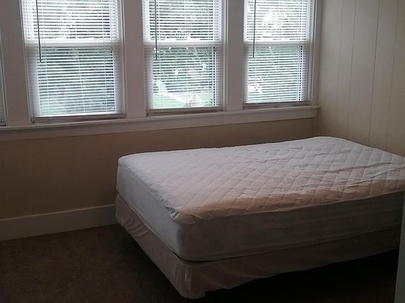 Front bedroom furnished with dresser, nightstand, and bed (new mattress cover)