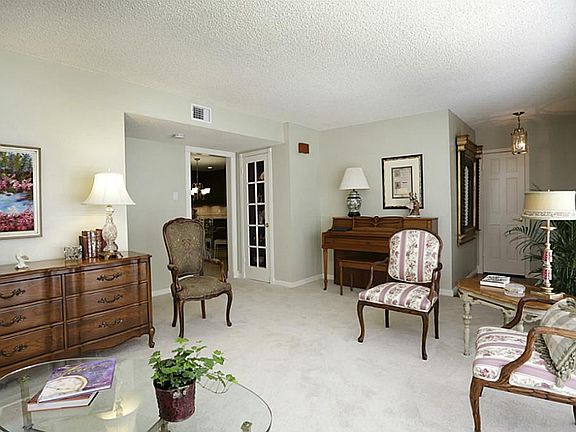 Living room, looking back toward the entry and into the kitchen area. Carpet was recently replaced f