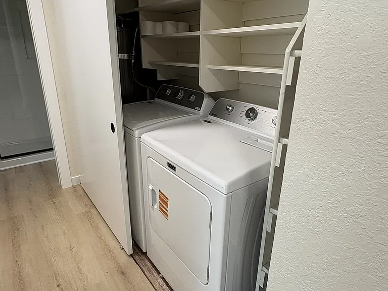 Extra large capacity dryer, with built in shelving units above for lots of great storage.
