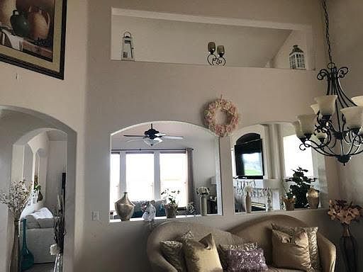 View of the dining room through to the family room and then the golf course beyond. The arch to the left enters the kitchen and breakfast nook.