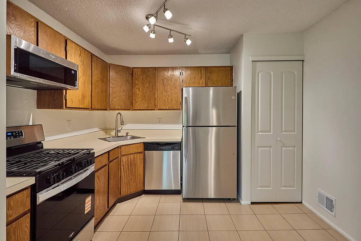 Functional kitchen featuring stainless steel appliances, gas cooking, and plenty of cabinet storage. - 425 Poets Way