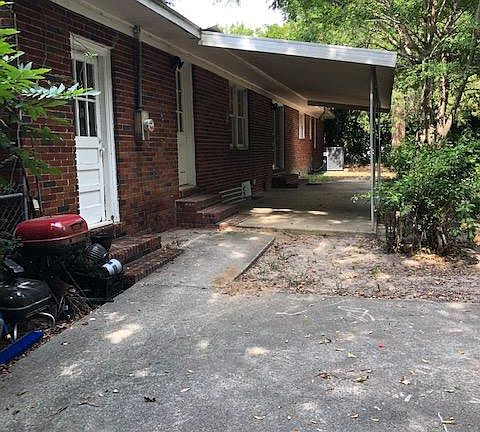 Back of home with covered patio