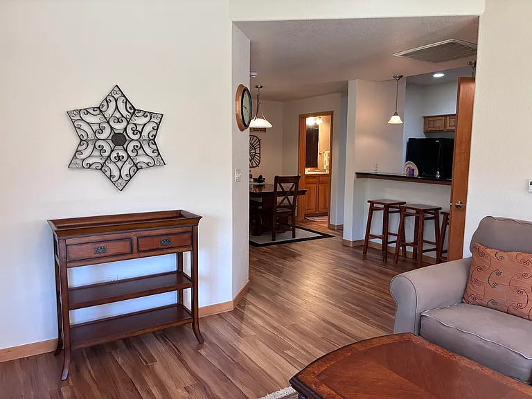From living room looking towards kitchen, dining and guest bath.