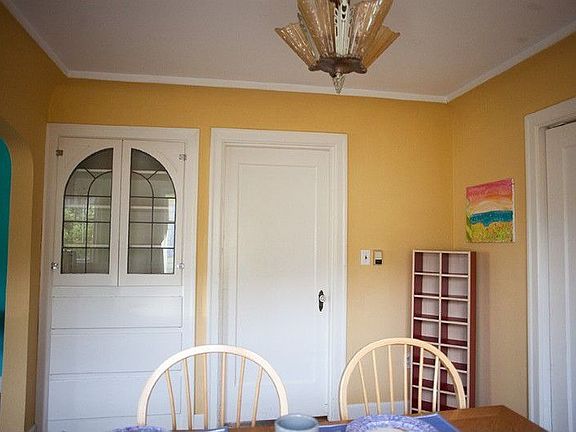 Another view of the pretty and convenient built-in dining room cabinet with pull-out drawers and shelving to display treasures behind leaded glass doors.