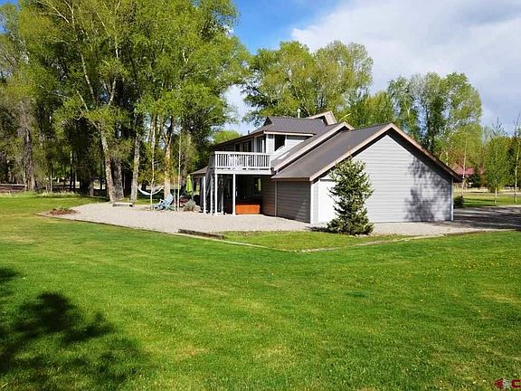 One acre, irrigated and landscaped lawns, mature trees and Gunnison River front.