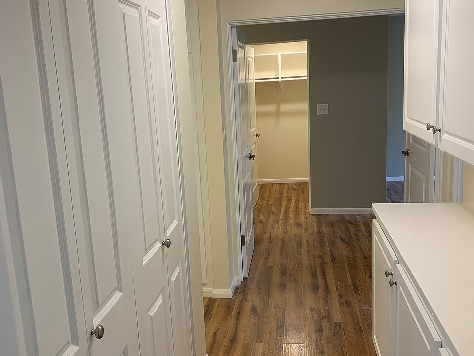 Laundry closet to left and ample cabinet storage to the right.