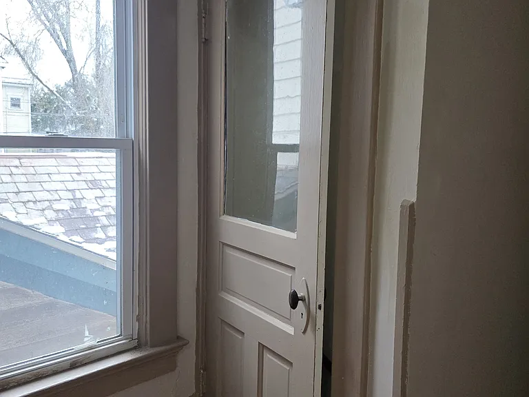 At the top of the stairs, a doorway into the back stairwell.