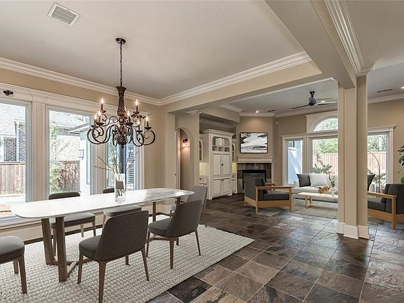 Desirable open floor plan has LR/DR/Kitchen with views to courtyard pool AND onto large backyard. Natural light abounds and the architectural details exude throughout this custom home. Primary Bedroom located through archway on left wall and also ove