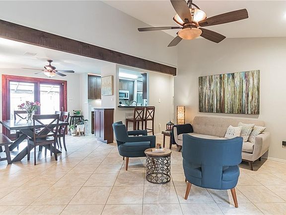 Open space, beautiful wooden beam between dining room and living room areas.