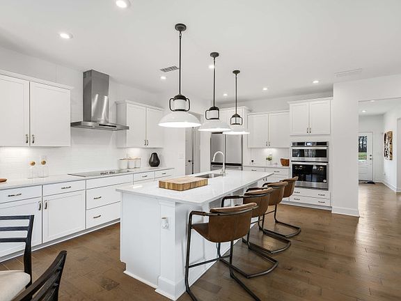 Gourmet Kitchen with a large island, double wall oven and a hood vent.