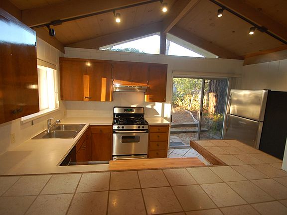 KITCHEN: Interior with high ceilings.
slider to fence back yard. has high counter for eating and a breakfast area.