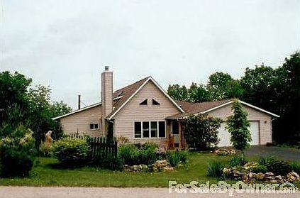 home front view in summer
						:
						South-facing front view of home