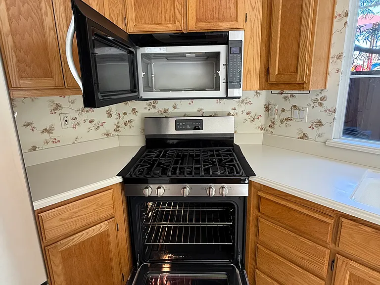 Kitchen with microwave and range stove.