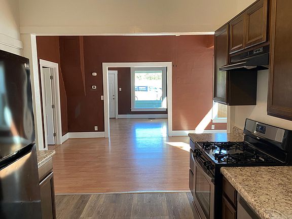 Kitchen looking through dining room and living room to the front door