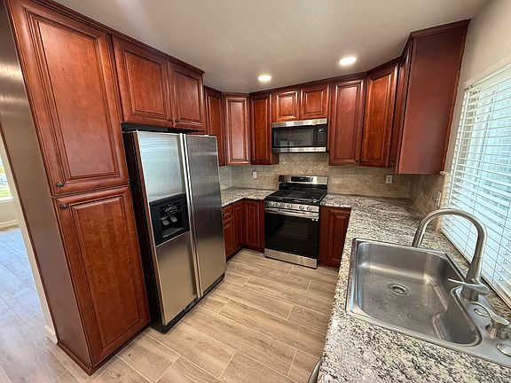 Kitchen showing included appliances, refrigerator, range, microwave and diswasher (not shown)