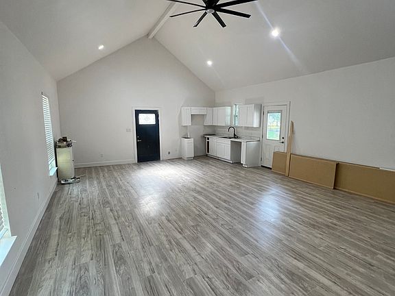 Living room showing kitchen cabinets and dining area