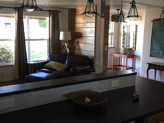 Entry area and corner of living room as viewed from kitchen.